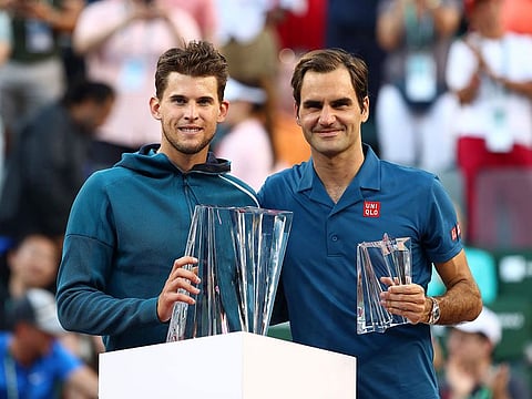 Dominic Thiem of Austria holds the championship trophy after his men's singles final victory against Roger Federer of Switzerland on day fourteen of the BNP Paribas Open at the Indian Wells Tennis Garden on March 17, 2019 in Indian Wells, California. 