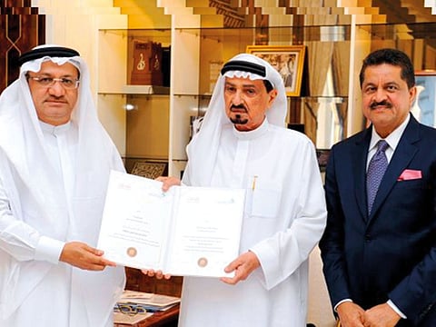 Shaikh Humaid being honoured by Humaid Al Qutami with the Personality of the Year Award at a special ceremony on the sidelines of the Dubai Health Awards. Thumbay Moideen is present.
