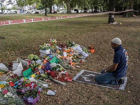 A man who said he frequented the Al Noor Mosque, but was away when a mass shooting occurred there days ago, prays at a makeshift memorial in front of the building, on Tuesday morning, March 19, 2019.