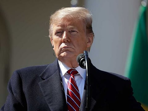 President Donald Trump listens during a news conference with Brazilian President Jair Bolsonaro in the Rose Garden of the White House.