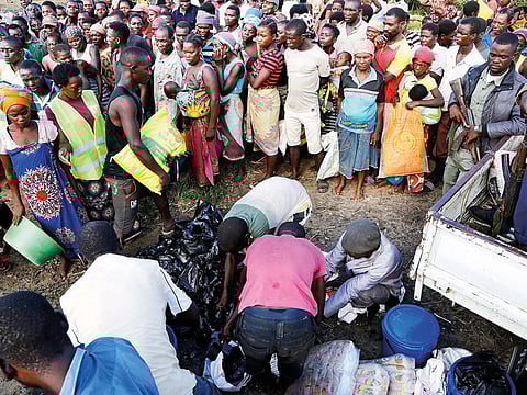 Mozambicans queue up to receive food from the World Food Programme in Nhamatanda, 100km from Beira. A week after Cyclone Idai, flooding still raged Thursday due to torrential rains.