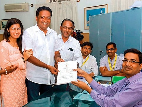 Multilingual actor Prakash Raj with family members poses for photos as he files his nomination as an independent candidate contesting from Bengaluru Central constituency