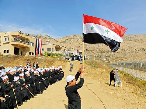 Druze people take part in a rally in Majdal Shams near the ceasefire line between Israel and Syria in the Israeli occupied Golan Heights, overlooking the other side of the border.