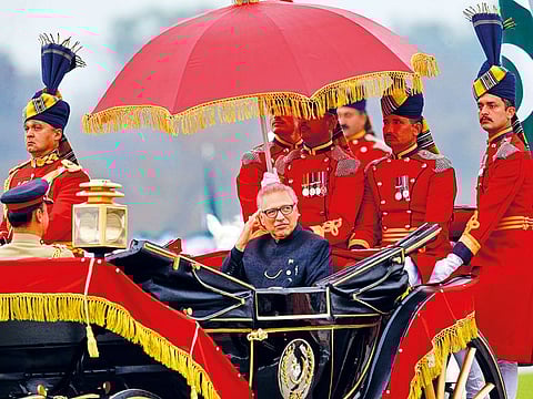 Pakistani President Arif Alvi salutes while he arrives to attend Pakistan National Day military parade in Islamabad, on Saturday. 