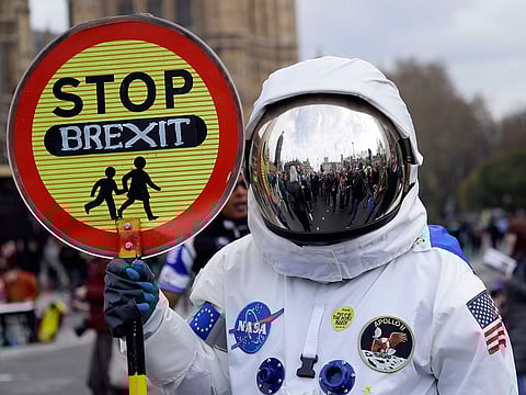 A demonstrator in an astronaut suit carries a sign during a Peoples Vote anti-Brexit march in London.