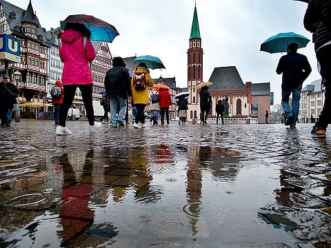 Tourists with umbrellas walk in the pouring rain on the Roemerberg square in in Frankfurt, Germany, Thursday, March 14, 2019. Photo for illustrative purposes.