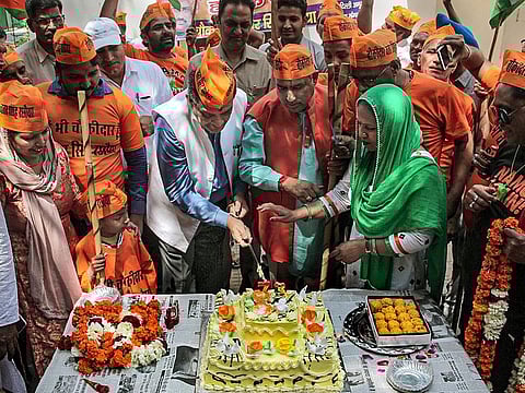 Union Minister of Steel Birender Singh cuts a cake as he promotes party's campaign 'Main bhi Chowkidaar' at his residence, in New Delhi, Sunday, March 24, 2019.