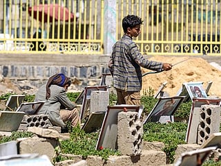 After school, Yemen's children seek work at the cemetery