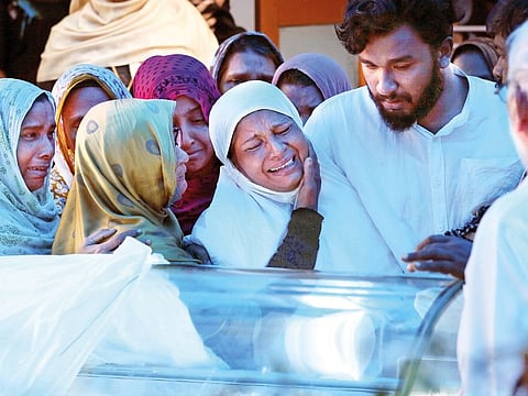 The mother of Anzi Ali Bhava, who died in mosque shootings in New Zealand, cries as her daughter's body is brought to her house before a funeral in Kodungalloor town in the southern state of Kerala, India, March 25, 2019