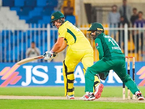Australia's Aaron Finch (L) plays a shot during the second one day international (ODI) cricket match against Pakistan in Sharjah, on March 24, 2019. 