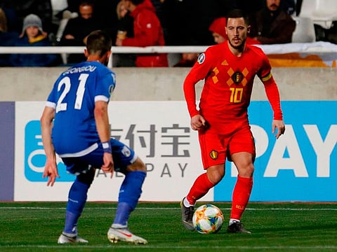 Belgium's forward Eden Hazard (R) is marked by Cyprus' midfielder Anthony Georgiou (L) during the Euro 2020 Group I football qualification match between Cyprus and Belgium at the GSP Stadium in Nicosia, on March 24, 2019. 