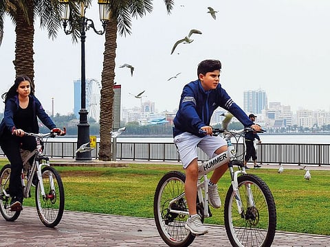 People enjoy the pleasant weather in Sharjah.