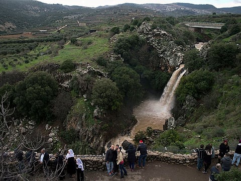 People visit the Sa'ar waterfall, near the Druze village of Ein Qiniyya in the Israeli-occupied side of Golan Heights. 