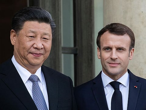 Xi Jinping, China’s president, left, and Emmanuel Macron, France's president, pose for photographs in the courtyard of Elysee Palace in Paris, France, on Tuesday, March 26, 2019.  