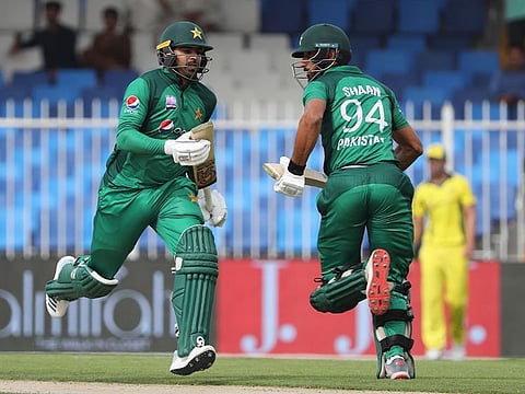 Pakistan's Shan Masood (R) and Haris Sohail run between the wickets during the second one day international (ODI) cricket match between Pakistan and Australia in Sharjah, on March 24, 2019. 