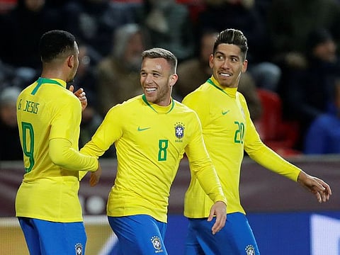 Brazil's Gabriel Jesus celebrates scoring their second goal with Arthur and Roberto Firmino.