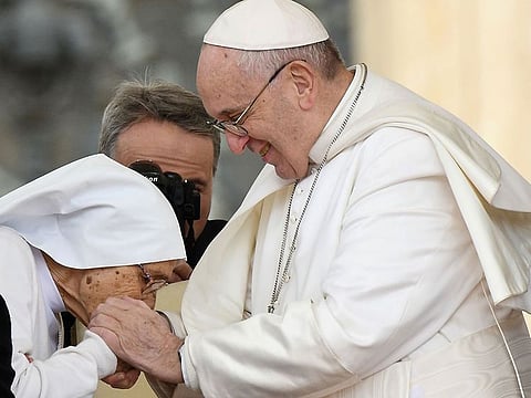 Pope Francis pays homage to 85-year-old Sr. Maria Concetta Esu (L) giving her a Pro Ecclesia et Pontifice award during his weekly general audience, in St. Peter's Square at the Vatican, on March 27, 2019.
