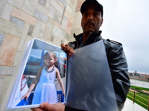 Tarbouni displays a picture of his niece as he tries to find her in Syria in the northern town of Qamishli. 