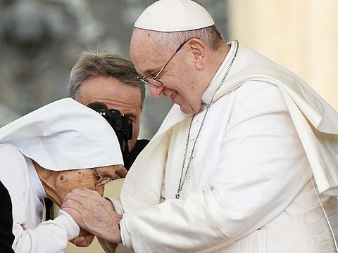 Pope Francis pays homage to 85-year-old Sr. Maria Concetta Esu (L) giving her a Pro Ecclesia et Pontifice award during his weekly general audience, in St. Peter's Square at the Vatican, on March 27, 2019.  