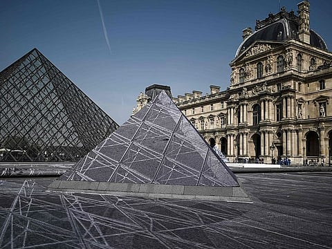 The Louvre pyramid is seen during preparations of the installation of French contemporary artist and photographer Jean Rene, aka JR in the main courtyard Cour Napoleon of the Louvre Museum in Paris on March 28, 2019, as part of the 30th anniversary celebrations of the Louvre Pyramid.