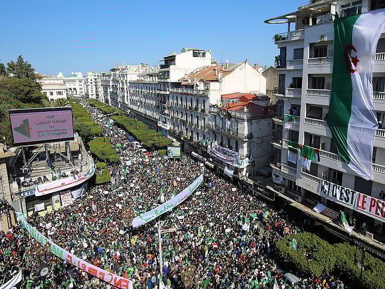 People carry national flags and banners