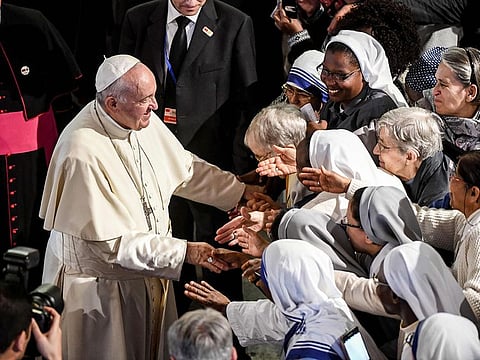 Pope Francis greets worshippers as he departs from St Peter's Roman Catholic Cathedral in the Moroccan capital Rabat 