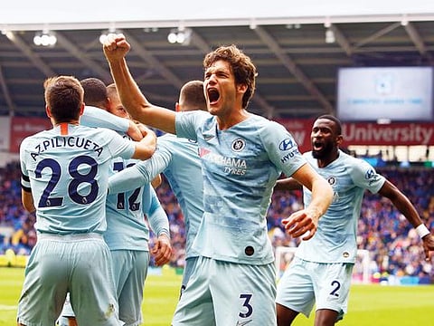 Chelsea's Marcos Alonso (C) celebrates the winning goal from Ruben Loftus-Cheek during the English Premier League football match against Cardiff City at Cardiff City Stadium in Cardiff. 