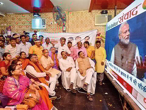 Union Minister Ravi Shankar Prasad along with party workers watch the live telecast of PM Narendra Modi’s speech as part of the ‘Main bhi Chowkidar’ campaign, in Patna, on Sunday.