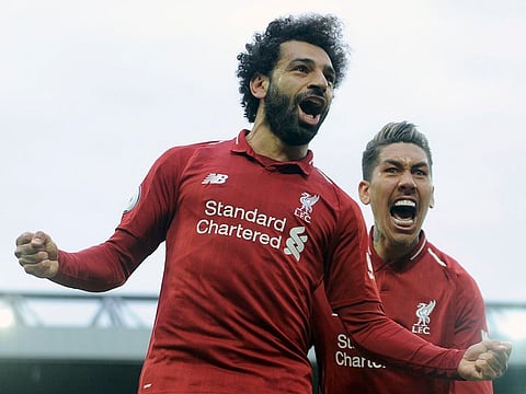 Liverpool's Mohammad Salah, left, and Liverpool's Roberto Firmino celebrate after Tottenham's Toby Alderweireld scores an own goal.