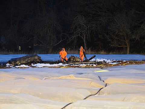 Emergency services among burnt out debris of a small aircraft on a field near the small airport of Egelsbach near Frankfurt, Germany, Sunday, March 31, 2019, which crashed on approach to the airport. 
