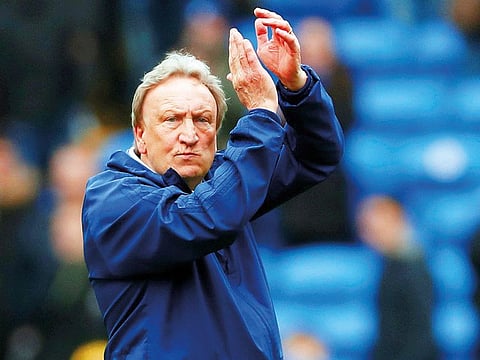 Cardiff City manager Neil Warnock applauds the fans after the match.