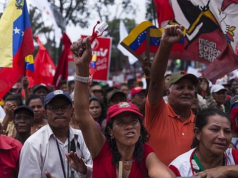 Pro-government supporters cheer during an anti-imperialist rally in Caracas, Venezuela.