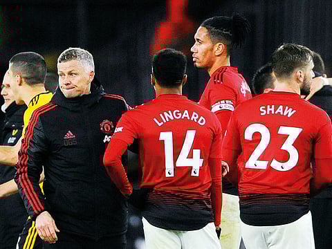 United manager Solskjaer talks with players Jesse Lingard, Chris Smalling and Luke Shaw at the end of the match with Wolverhampton Wanderers at the Molineux Stadium in Wolverhampton, England, on Tuesday. Wolverhampton won 2-1.