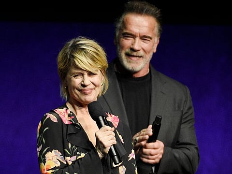 Linda Hamilton, a cast member in the upcoming film "Terminator: Dark Fate," addresses the audience as fellow cast member Arnold Schwarzenegger looks on.