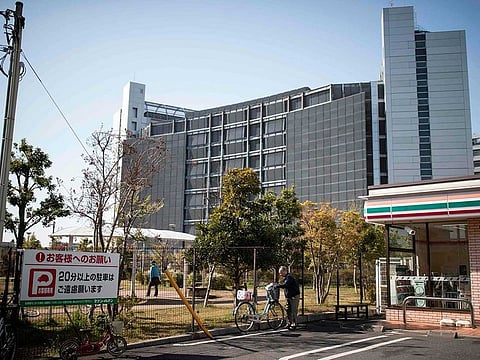 A man parks his bicycle outside Tokyo Detention House, where former Nissan chairman Carlos Ghosn is being held, in Tokyo.