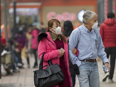 People walking at Wangfujing Street under a heavy smog day.