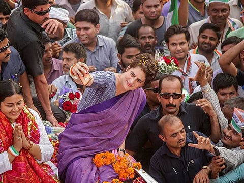 Congress Party General Secretary Priyanka Gandhi Vadra clicks a selfie with her party supporters during a roadshow, ahead of the Lok Sabha polls, in Ghaziabad.
