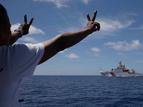 In this March 29, 2014, file photo,  China Coast Guard vessel attempts to block a Philippine government vessel as the latter tries to enter the China Second Thomas Disputed Shoals, locally known as Ayungin Shoal, to orate Philippine troops and resupply provisions.
