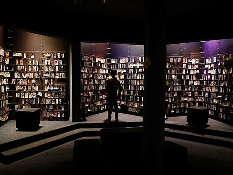 A visitor looks at an exhibition displaying pictures of the Rwandan Genocide victims donated by survivors at the Genocide Memorial in Gisozi in Kigali, Rwanda April 6, 2019.