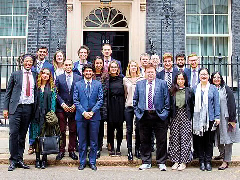 The 16 students of NYU Abu Dhabi with officials in front of 10 Downing Street in London during their visit.