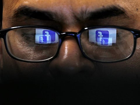 Facebook logo is reflected in glasses in this picture illustration. 