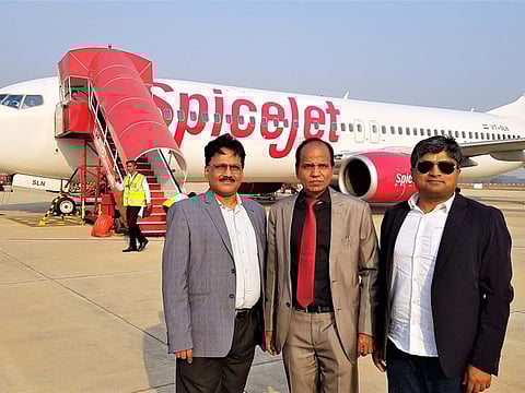 Indian expats Manas Panda, director of an electrical company, and Priydarshee Panigrahi, general manager of a consumer goods company, flank S.K. Chauhan, director of Jharsuguda Airport on the day of the Delhi-Jharsuguda inaugural flight.