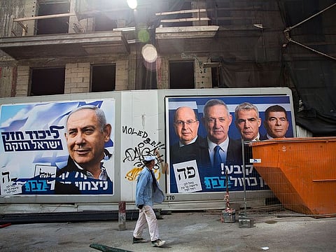 Hebrew on billboards reads, left "Strong Likud strong Israel" on the right "Every vote matters, win Blue and White". 