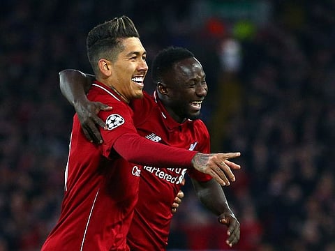 Liverpool's Naby Keita celebrates with Roberto Firmino, left, after scoring the opening goal.