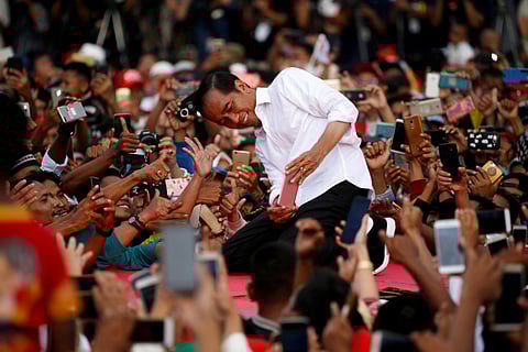 Joko Widodo takes a selfie with his supporters during his first campaign rally at a stadium in Serang, Banten province, Indonesia, on March 24.