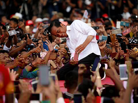 Joko Widodo takes a selfie with his supporters during his first campaign rally at a stadium in Serang, Banten province, Indonesia, on March 24.