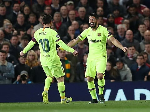 Barcelona's Luis Suarez celebrates their first goal with Lionel Messi.