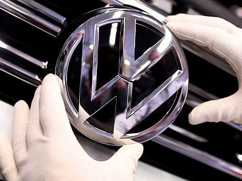 A Volkswagen badge on a production line at the Volkswagen plant in Wolfsburg, Germany.