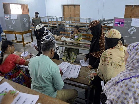 Indian Muslim voters check their names on lists to cast their vote at a polling station in Kurnool district of the Indian state of Andhra Pradesh, on April 11, 2019.