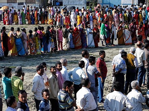 Voters line up to cast their votes outside a polling station during elections in Alipurduar district, West Bengal